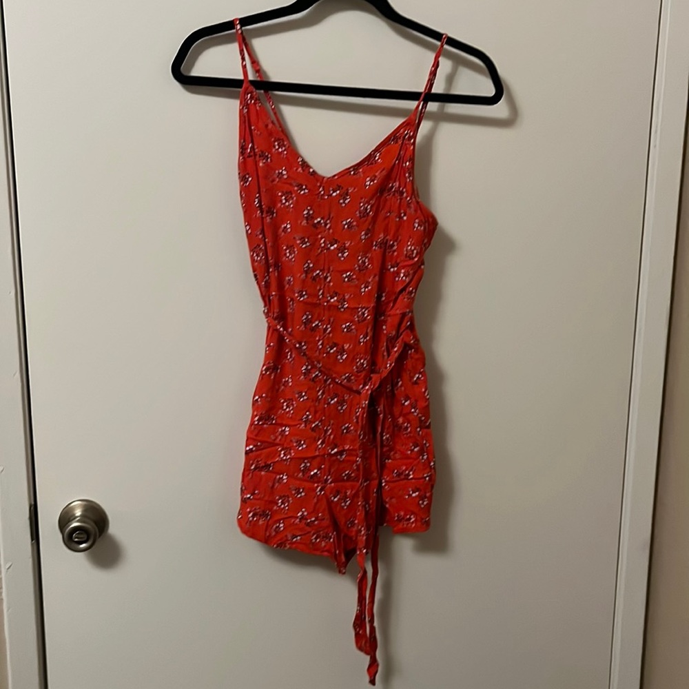 Red romper with white flowers size small